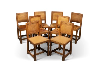Lot 744 - ROBERT THOMPSON OF KILBURN, A SET OF EIGHT MOUSEMAN OAK PANEL-BACK DINING CHAIRS