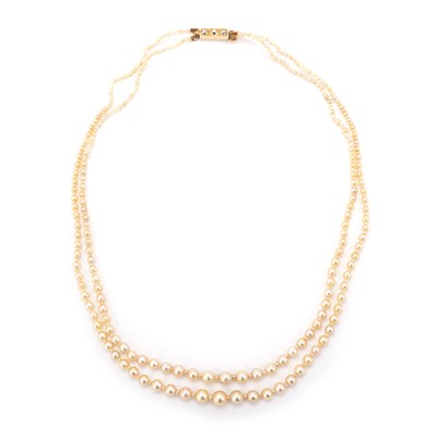 Lot 604 - A NATURAL SALTWATER DOUBLE STRAND GRADUATED PEARL NECKLACE