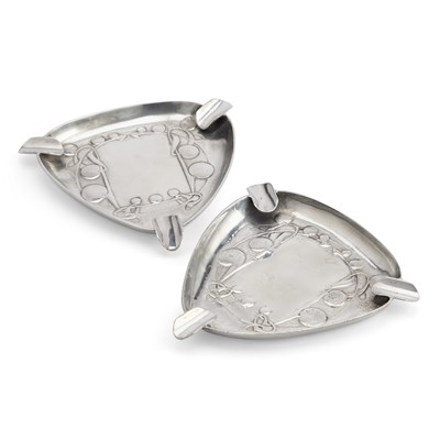 Lot 214 - ARCHIBALD KNOX (1864-1933) FOR LIBERTY & CO, A PAIR OF TUDRIC PEWTER ASHTRAYS