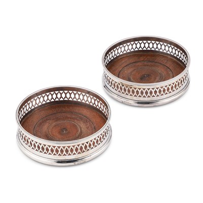 Lot 342 - A PAIR OF GEORGE III STYLE SILVER WINE COASTERS