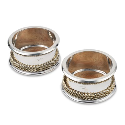 Lot 343 - THEO FENNELL: A PAIR OF ELIZABETH II PARCEL-GILT SILVER WINE COASTERS