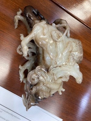 Lot 114 - A CHINESE BLACK AND WHITE JADE 'MYTHICAL BEAST' VASE AND COVER