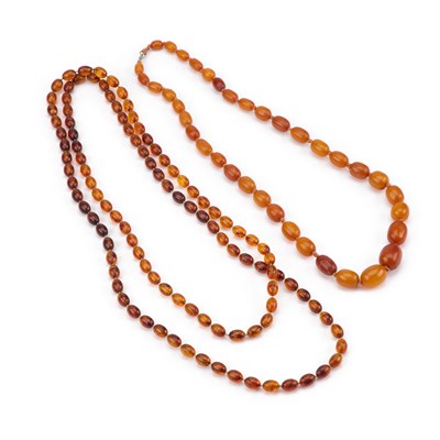 Lot 450 - TWO COMPOSITE AMBER COLOURED BEAD NECKLACES
