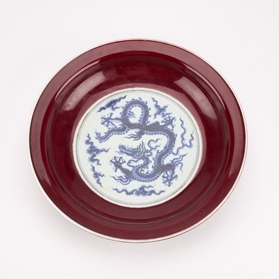 Lot 157 - A CHINESE UNDERGLAZE BLUE AND SANG-DE-BOEUF 'DRAGON' DISH