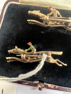 Lot 568 - A PAIR OF EARLY 20TH CENTURY DIAMOND AND ENAMEL JOCKEY BROOCHES