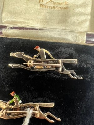 Lot 568 - A PAIR OF EARLY 20TH CENTURY DIAMOND AND ENAMEL JOCKEY BROOCHES