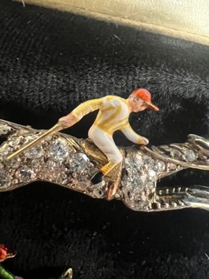 Lot 568 - A PAIR OF EARLY 20TH CENTURY DIAMOND AND ENAMEL JOCKEY BROOCHES