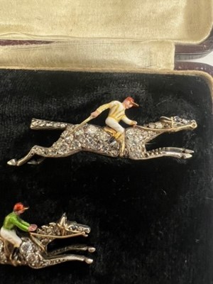 Lot 568 - A PAIR OF EARLY 20TH CENTURY DIAMOND AND ENAMEL JOCKEY BROOCHES