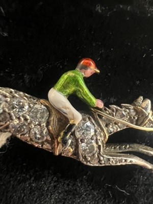 Lot 568 - A PAIR OF EARLY 20TH CENTURY DIAMOND AND ENAMEL JOCKEY BROOCHES