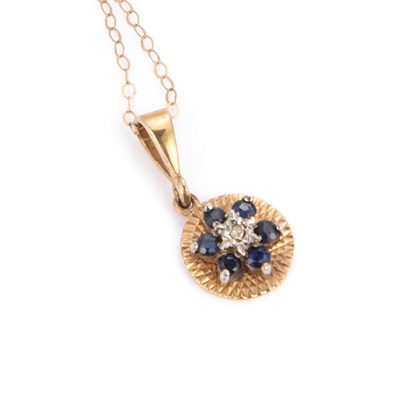 Lot 686 - A 9 CARAT GOLD SAPPHIRE AND DIAMOND PENDANT ON CHAIN