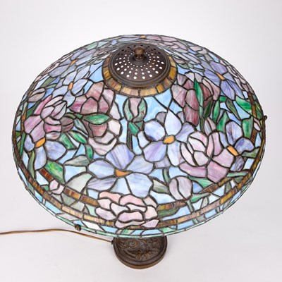Lot 931 - A TIFFANY STYLE BRONZE TABLE LAMP WITH A LEADED AND STAINED GLASS SHADE