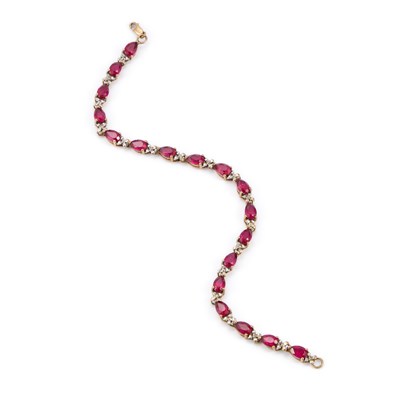 Lot 908 - A 9 CARAT GOLD RUBY AND DIAMOND LINE BRACELET