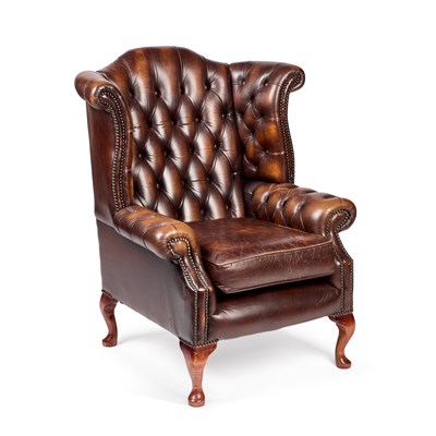 Lot 456 - A GEORGIAN STYLE DEEP-BUTTONED BROWN LEATHER WING-BACK ARMCHAIR
