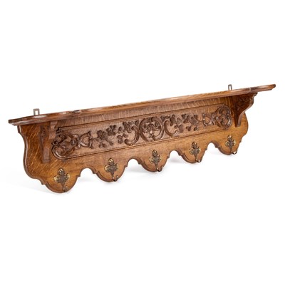 Lot 853 - A CONTINENTAL CARVED OAK HANGING COAT RACK