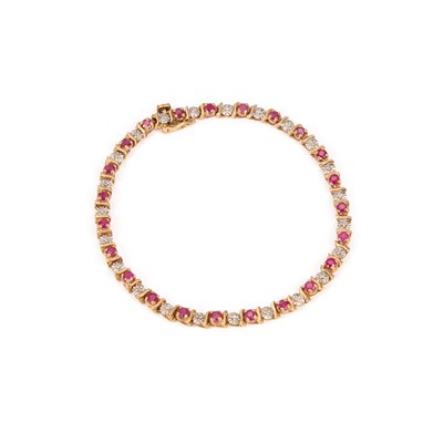 Lot 528 - A 9 CARAT GOLD RUBY AND DIAMOND BRACELET