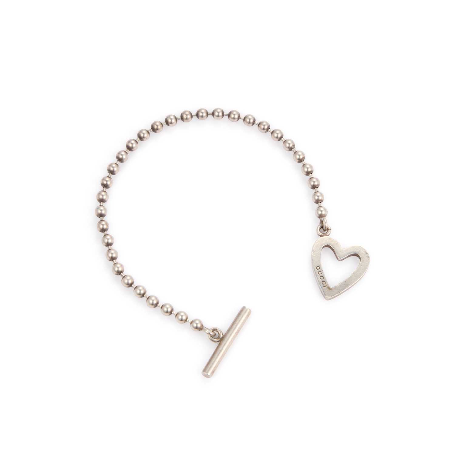 Lot 520 - GUCCI, A SILVER HEART BRACELET