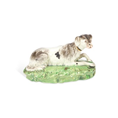 Lot 40 - A STAFFORDSHIRE POTTERY MODEL OF A RECUMBENT HOUND