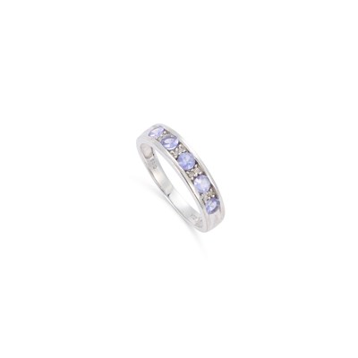 Lot 377 - A 9 CARAT WHITE GOLD TANZANITE AND DIAMOND HALF HOOP RING