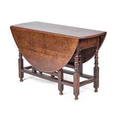 Lot 644 - AN OAK GATELEG DINING TABLE