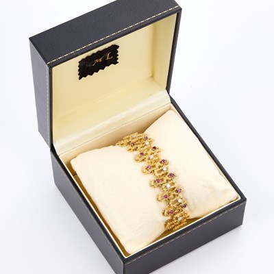 Lot 424 - A RUBY AND DIAMOND ABSTRACT TEXTURED BRACELET