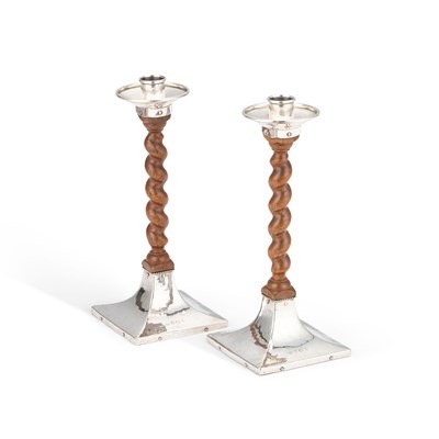 Lot 342 - A PAIR OF ARTS AND CRAFTS SILVER AND OAK CANDLESTICKS