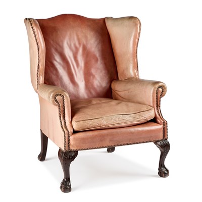 Lot 1049 - A GEORGIAN STYLE CARVED MAHOGANY AND LEATHER WING-BACK ARMCHAIR
