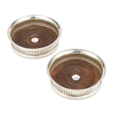 Lot 516 - A PAIR OF GEORGE III SILVER WINE COASTERS