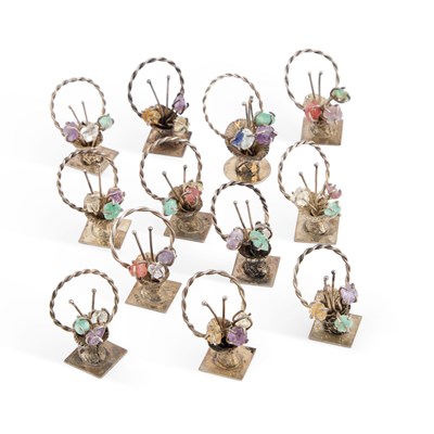 Lot 331 - A SET OF TWELVE SILVER AND 'JEWELLED' MENU HOLDERS
