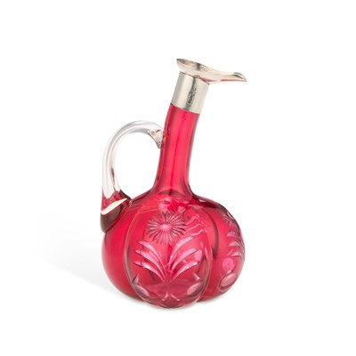 Lot 278 - AN EDWARDIAN SILVER-MOUNTED CRANBERRY GLASS EWER