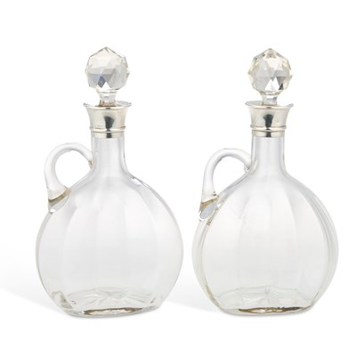 Lot 333 - A PAIR OF EDWARDIAN SILVER-COLLARED GLASS DECANTERS