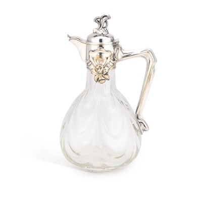 Lot 211 - AN ART NOUVEAU SILVER-PLATE MOUNTED GLASS CLARET JUG