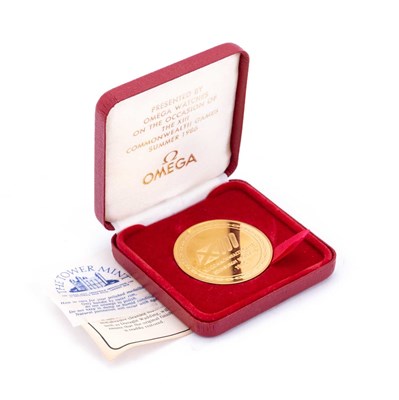 Lot 723 - A THE TOWER MINT COMMEMORATIVE GOLD PLATED OMEGA MEDALLION