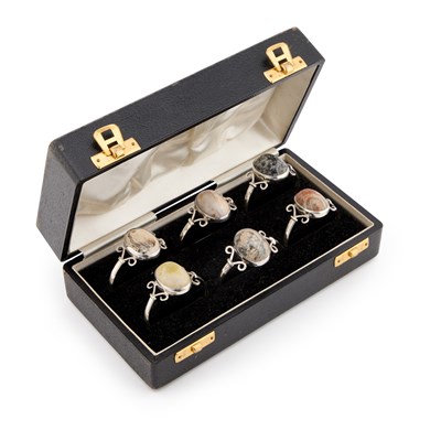 Lot 352 - A SET OF SIX STERLING SILVER AND HARDSTONE NAPKIN RINGS