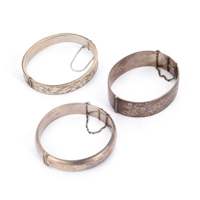 Lot 704 - THREE SILVER HINGED BANGLES