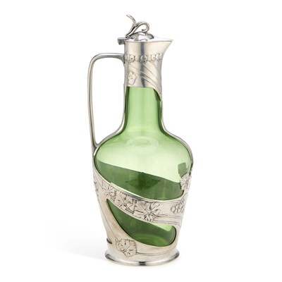 Lot 181 - AN ART NOUVEAU GREEN GLASS CLARET JUG WITH PEWTER MOUNTS