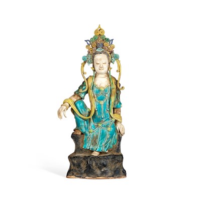 Lot 557 - A CHINESE POLYCHROME-GLAZED POTTERY FIGURE OF GUANYIN