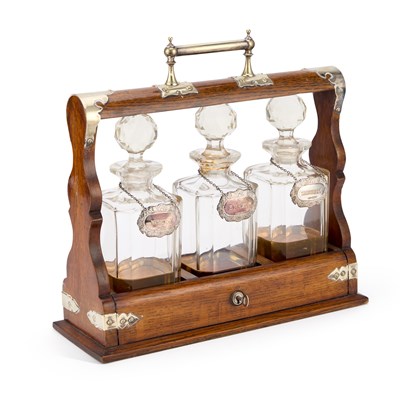 Lot 164 - AN EARLY 20TH CENTURY SILVER-PLATE MOUNTED OAK TANTALUS