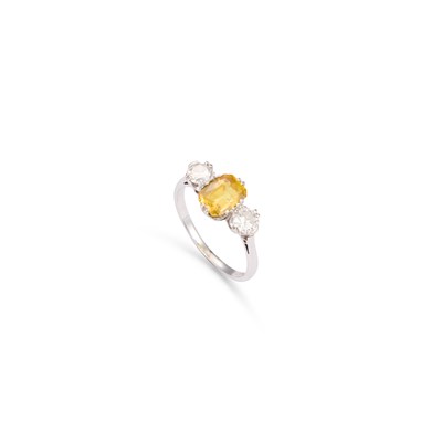 Lot 838 - A YELLOW SAPPHIRE AND DIAMOND THREE STONE RING