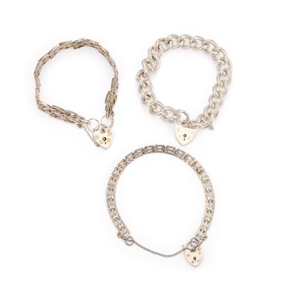 Lot 781 - THREE SILVER HEART PADLOCK CLASP BRACELETS