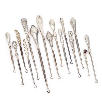 Lot 322 - A COLLECTION OF FOURTEEN SILVER-HANDLED BUTTON HOOKS