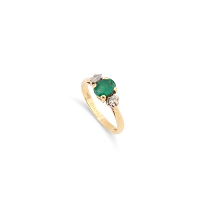 Lot 825 - AN 18 CARAT GOLD EMERALD AND DIAMOND THREE STONE RING