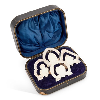 Lot 530 - A CASED SET OF FOUR EDWARDIAN SILVER 'CARD SUIT' MENU HOLDERS