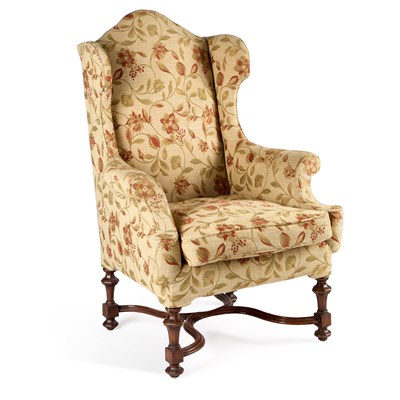 Lot 1141 - A LATE 19TH CENTURY WALNUT AND UPHOLSTERED WING-BACK ARMCHAIR