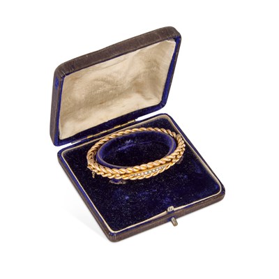 Lot 888 - A VICTORIAN GOLD AND SEED PEARL HINGE OPENING BANGLE