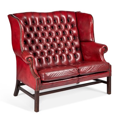 Lot 1213 - A GEORGIAN STYLE DEEP-BUTTONED RED LEATHER WING-BACK SETTEE