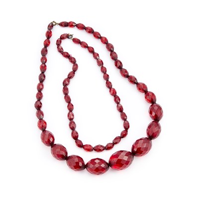 Lot 653 - TWO PRYSTAL CHERRY AMBER BAKELITE BEAD NECKLACES