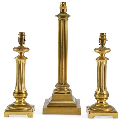 Lot 1021 - A GROUP OF THREE BRASS COLUMNAR OIL LAMPS