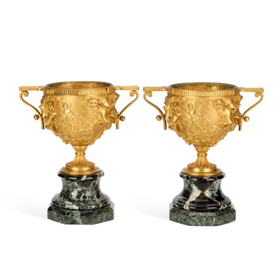 Lot 704 - A PAIR OF FRENCH GILT-BRONZE TWO-HANDLED URNS