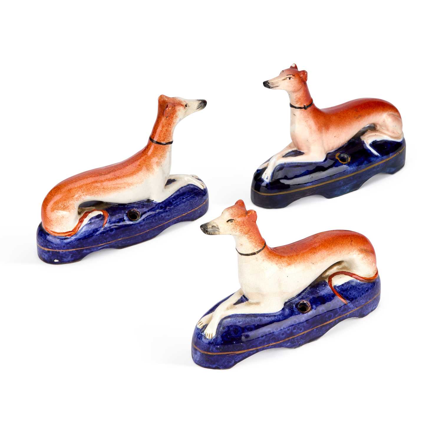 Lot 84 - THREE VICTORIAN STAFFORDSHIRE POTTERY GREYHOUND PEN HOLDERS