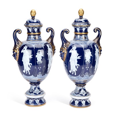 Lot 242 - A LARGE PAIR OF CONTINENTAL PORCELAIN COVERED URNS